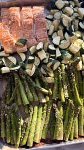 A sheet pan of salmon with zucchini and asparagus.